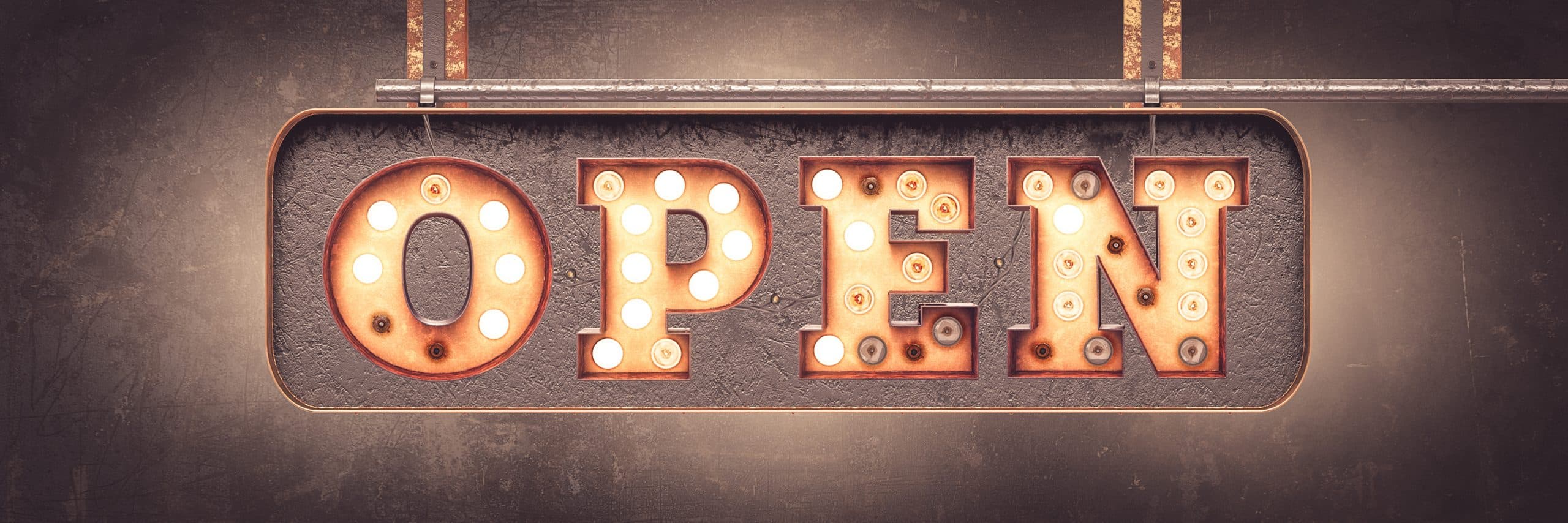 Illuminated marquee sign spelling OPEN on a restaurant wall